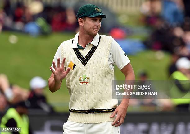 Australia's paceman Josh Hazlewood acknowledges applaus from the spectators on the third day's play of the second Test cricket match between...