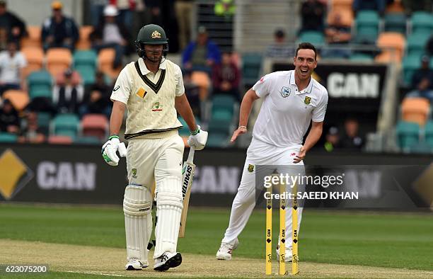 South Africa's paceman Kyle Abbott celebrates his first wicket of Australia's Joe Burns on the third day's play of the second Test cricket match...