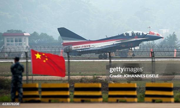 This picture taken on November 11, 2014 shows Chinese female J-10 fighter pilot Yu Xu taking off at the Airshow China in Zhuhai, south China's...