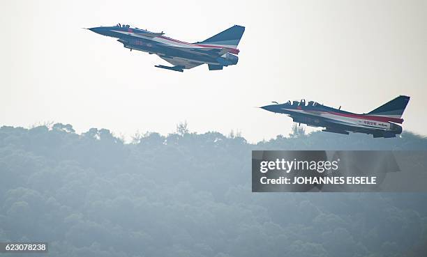 This picture taken on November 11, 2014 shows Chinese female J-10 fighter pilot Yu Xu performing at the Airshow China in Zhuhai, south China's...