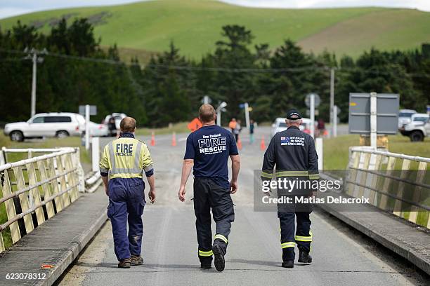 Emergency services inspect a bridge crossing the Waiau River in Rotherham Road, 110 kms north of Christchurch, as damage and land slip cause...