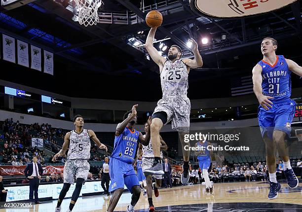 Patricio Garino of the Austin Spurs leaps to the basket past Daniel Hamilton of the Oklahoma City Blue at the HEB Center At Cedar Park on November...