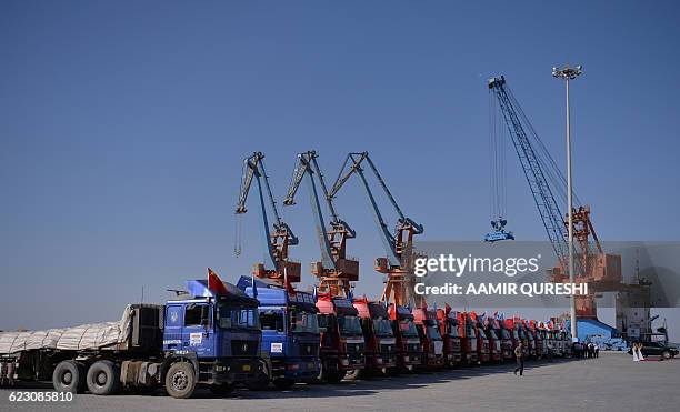 Chinese trucks stand on a pontoon during the opening of a trade project in Gwadar port, some 700 kms west of the Pakistani city of Karachi on...