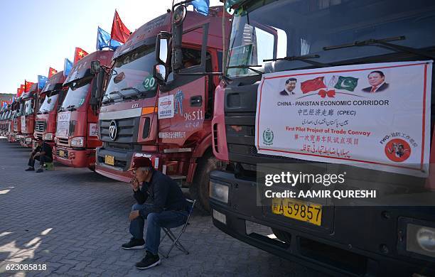 Chinese worker sits near trucks carrying goods during the opening of a trade project in Gwadar port, some 700 kms west of the Pakistani city of...