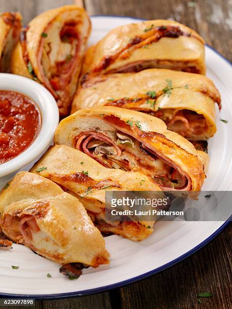 stromboli with pepperoni, salami, mushrooms and peppers - salami stock pictures, royalty-free photos & images