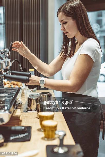 barista is making a coffee - hipster coffee shop candid stock pictures, royalty-free photos & images