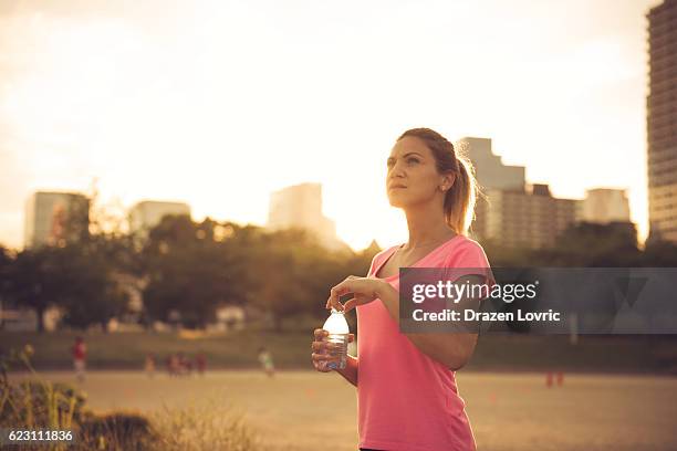 resting after jogging in summer afternoon - sepia toned stock pictures, royalty-free photos & images