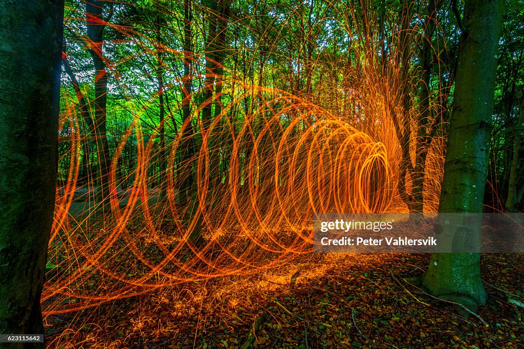 Rotating burning steel wool in forest