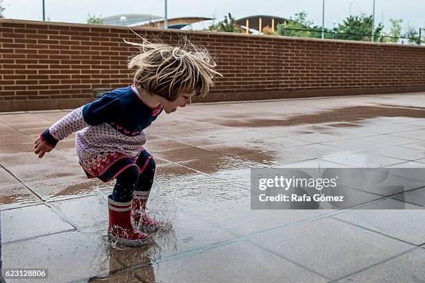 loving the puddles - jugar stock pictures, royalty-free photos & images