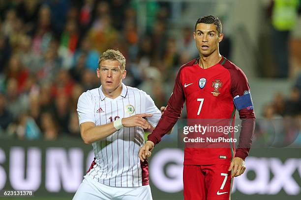 Portugals forward Cristiano Ronaldo and Latvia's midfielder Roberts Savalnieks from Latvia during the 2018 FIFA World Cup Qualifiers matches between...