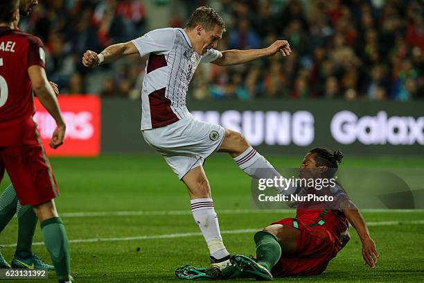 Latvia's forward Arjoms Rudnevs from Latvia and Portugals defender Bruno Alves during the 2018 FIFA World Cup Qualifiers matches between Portugal and...