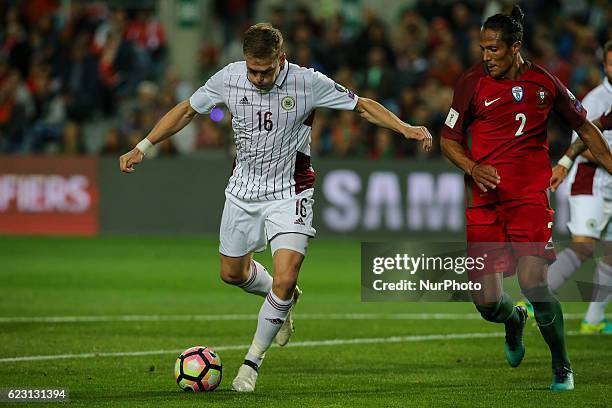 Latvia's forward Arjoms Rudnevs from Latvia and Portugals defender Bruno Alves during the 2018 FIFA World Cup Qualifiers matches between Portugal and...