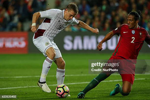 Latvia's forward Arjoms Rudnevs from Latvia and Portugals defender Bruno Alves during the 2018 FIFA World Cup Qualifiers matches between Portugal and...