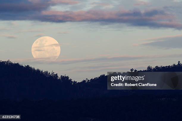 The moon rises over the city of Hobart, on November 14, 2016 in Hobart, Australia. A super moon occurs when a full moon passes closer to earth than...