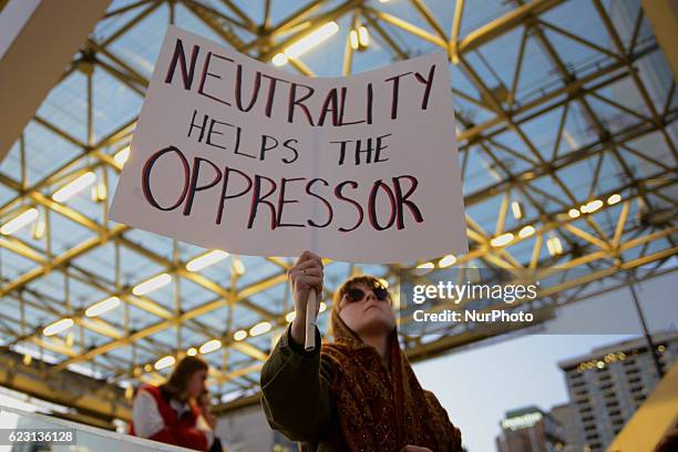 Group of Trump protesters, holding various banners, peacefully gather on 13 November in Toronto, Canada came to the streets to show solidarity with...