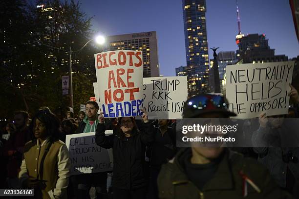 Group of Trump protesters, holding various banners, peacefully gather on 13 November in Toronto, Canada came to the streets to show solidarity with...