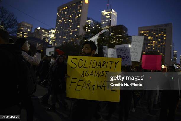 Group of Trump protesters, holding various banners, peacefully gather on 13 November in Toronto, Canada came to the streets to show solidarity with...