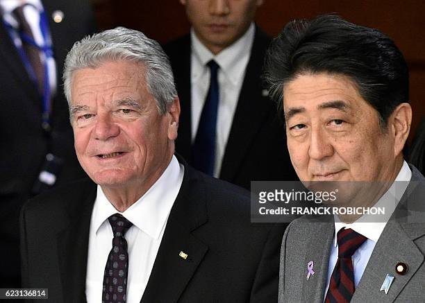 German President Joachim Gauck and Japan's Prime Minister Shinzo Abe walk on their way to their meeting at Abe's official residence in Tokyo on...