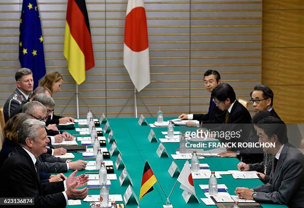 German President Joachim Gauck speaks to Japan's Prime Minister Shinzo Abe at the start of their meeting at Abe's official residence in Tokyo on...