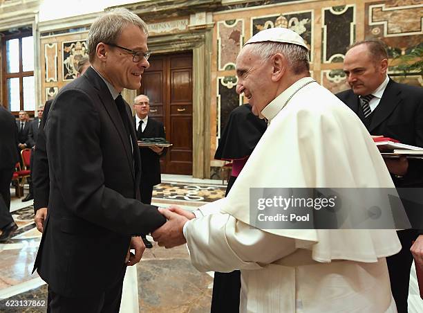 Executive Board member Peter Peters shakes hands with Pope Francis during a private audience with Pope Francis at the Vatican Palace on November 14,...