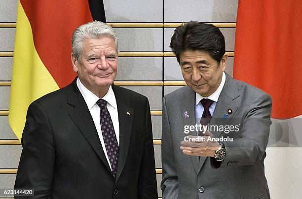 German President Joachim Gauck is greeted by Japan's Prime Minister Shinzo Abe at the beginning of their meeting at Abe's official residence in...