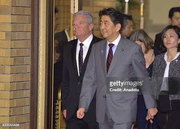 German President Joachim Gauck is escorted by Japan Prime Minister Shinzo Abe as they arrive at the dinner hosted by Prime Minister Shinzo Abe at...