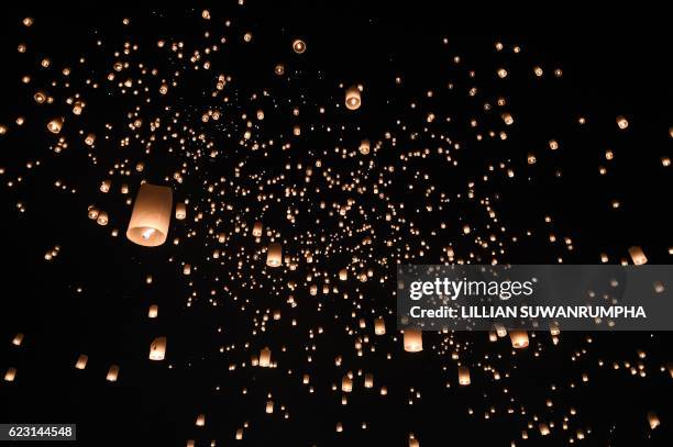 People release thousands of paper lanterns to mark the annual Yi Peng festival in the popular tourist city of Chiang Mai in the north of Thailand on...