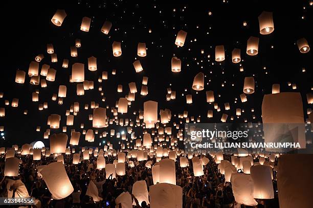 People release thousands of paper lanterns to mark the annual Yi Peng festival in the popular tourist city of Chiang Mai in the north of Thailand on...