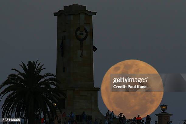 Crowds look on as the super moon rises behind the Fremantle War Memorial at Monument Hill on November 14, 2016 in Fremantle, Australia. A super moon...
