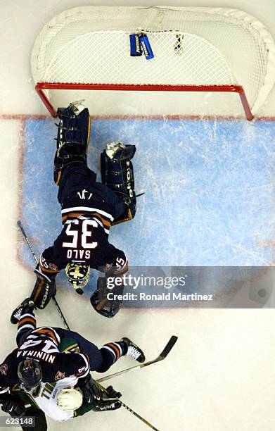 Goalie Tommy Salo makes the save on Dallas Stars winger Brett Hull while being defended by Janne Niinimaa of the Edmonton Oilers during Game 1 of the...