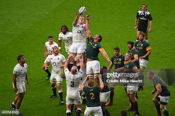 Joe Launchbury of England wins lineout ball under pressure from Eben Etzebeth of South Africa during the Old Mutual Wealth Series match between...