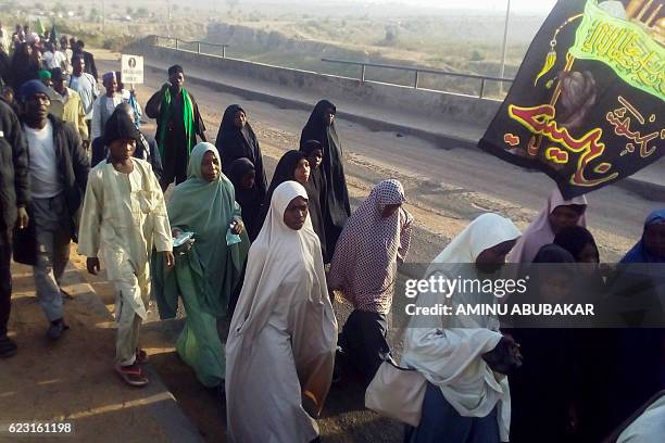 Members of pro-Iran Shiite group the Islamic Movement of Nigeria gather on the outskirts of the northern Nigerian city of Kano on November 14 during...