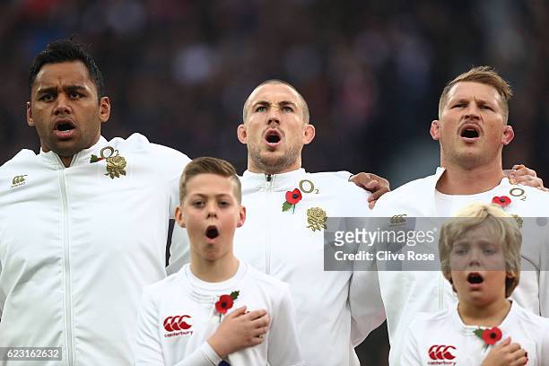 Billy Vunipola, Mike Brown and Dylan Hartley of England sing the national anthem prior to kickoff during the Old Mutual Wealth Series match between...