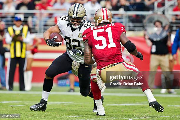 Tight end Coby Fleener of the New Orleans Saints turns with a catch against linebacker Gerald Hodges of the San Francisco 49ers in the first quarter...