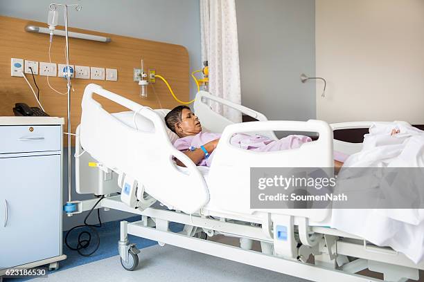 old woman on hospital bed, oxygen tubes in her nose - oxygen tube stock pictures, royalty-free photos & images