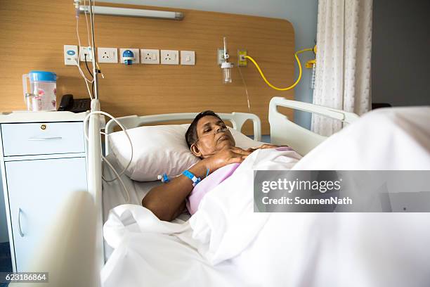 old woman on hospital bed, oxygen tubes in her nose - soumen nath stock pictures, royalty-free photos & images