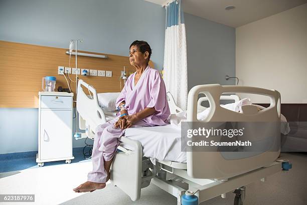 old woman patient sitting on a hospital bed - soumen nath stock pictures, royalty-free photos & images