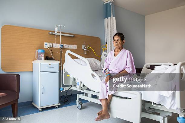 old woman patient sitting on a hospital bed - soumen nath stock pictures, royalty-free photos & images