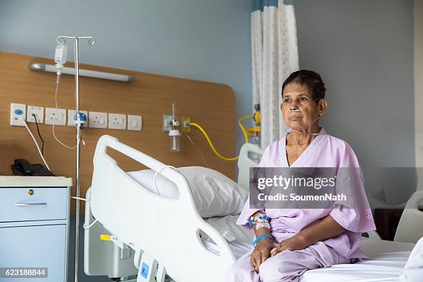 old woman patient sitting on a hospital bed - soumen nath stock pictures, royalty-free photos & images