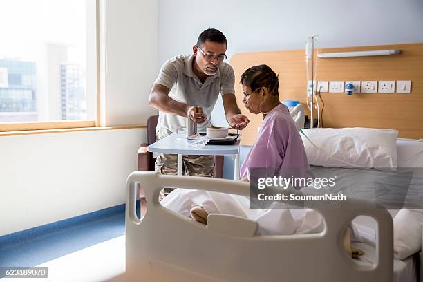 care for old woman patient in hospital - care home bed stock pictures, royalty-free photos & images