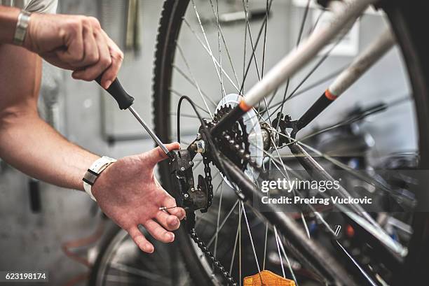 fixing the bicycle gear shift - bicycle tire stock pictures, royalty-free photos & images