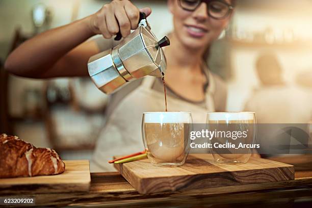 her coffee skills will keep you coming back for more - busy coffee shop stockfoto's en -beelden