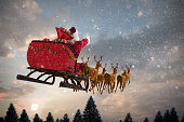 Santa Claus riding on sleigh with gift box