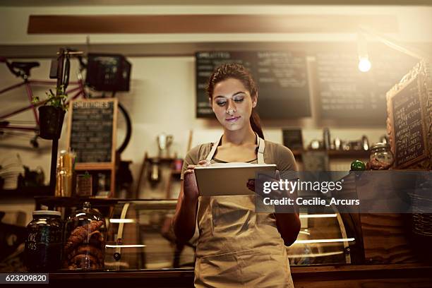 using technology to streamline daily coffee shop related tasks - waiter using digital tablet stock pictures, royalty-free photos & images