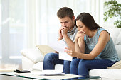 Worried couple reading a letter