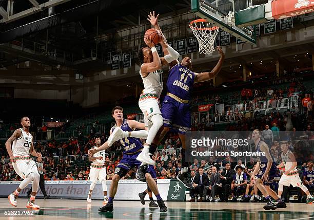 University of Miami guard Bruce Brown shoots against forward Charlendez Brooks during an NCAA basketball game between the Western Carolina University...