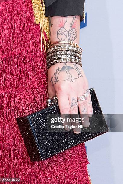 Singer-songwriter Elle King, clutch detail, attends the 50th annual CMA Awards at the Bridgestone Arena on November 2, 2016 in Nashville, Tennessee.