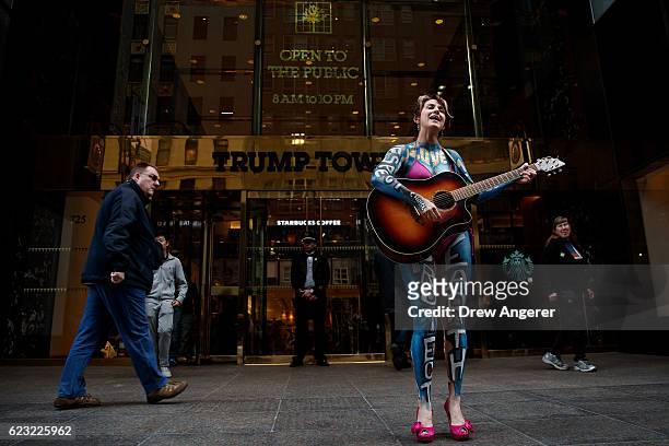 Gigi Love sings a song as she protests in front of Trump Tower, November 14, 2016 in New York City. Trump is in the process of choosing his...