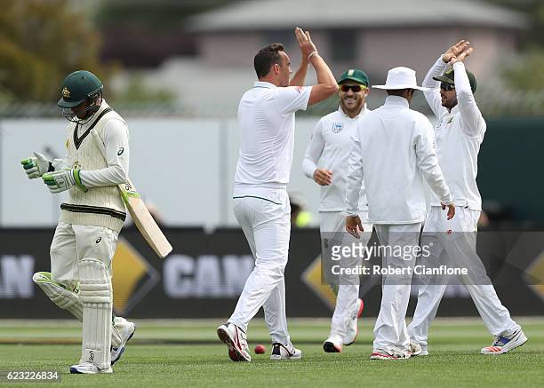 Kyle Abbott of South Africa celebrates after taking the wicket of Usman Khawaja of Australia during day four of the Second Test match between...