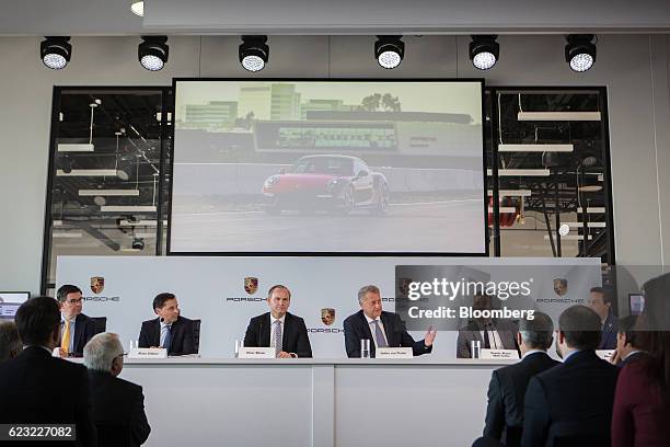 Christian Koenig, vice president of public relations for Porsche Cars North America Inc., from left, Klaus Zellmer, president and chief executive...